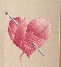 a pink heart with two knitting needles in it