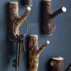 several pieces of wood are arranged on the wall with keys attached to them and hanging from hooks