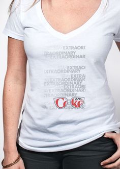 a woman wearing a white v - neck shirt with the words coca cola printed on it