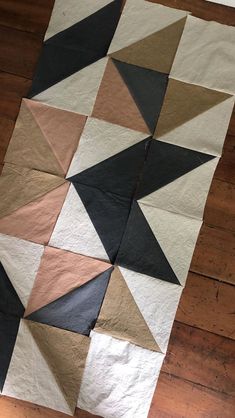 a piece of cloth that has been made into a pattern on the floor with wood floors