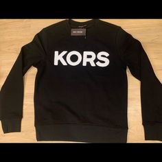 Michael Kors Men S Embroidered Logo Cotton Crewneck Sweatshirt Black Nwt M - Xl Black Logo Crew Neck Sweatshirt, Black Logo Sweatshirt With Crew Neck, Black Crew Neck Sweatshirt With Logo, Black Crew Neck Sweatshirt With Embroidered Logo, Black Embroidered Logo Crew Neck Sweatshirt, Black Long Sleeve Tops With Logo, Classic Long Sleeve Tops With Logo, Black Crew Neck Top With Logo Detail, Classic Winter Tops With Logo