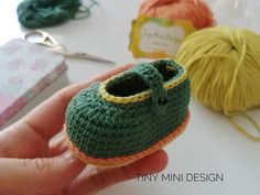 there is a small crocheted shoe in the hand