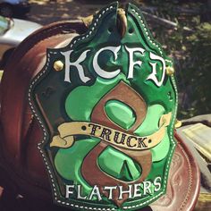 there is a green hat with the letters kfcfd and trucks on it