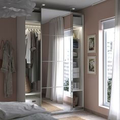 a bedroom with a large mirror closet next to a window