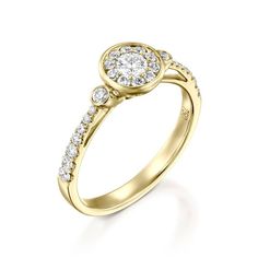 a yellow gold engagement ring with diamonds on the band and an oval shaped center stone