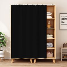 a black shower curtain hanging on a wall next to a shelf with shoes and other items