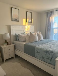 a bedroom with a bed, nightstands and pictures on the wall