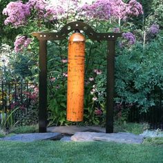 an orange fire hydrant sitting in the middle of a garden