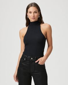 Crafted from a nylon blend with an elevated feel, this chic black tank top is designed with a pleated effect and a halter mock neck silhouette. The Momo Tank is the perfect layering piece to add to your year-round wardrobe. | Momo Tank Top - Black | Size Large Chic High Neck Tank Top For Night Out, Chic Black High Neck Halter Top, Chic Black Turtleneck Tank Top, Black Turtleneck Tank Top For Spring, Black High Neck Tank Top For Night Out, Sleek Black Sleeveless Halter Top, Sleek Black Halter Top For Night Out, Chic High Neck Tank Top For Layering, Black High Neck Halter Top For Spring