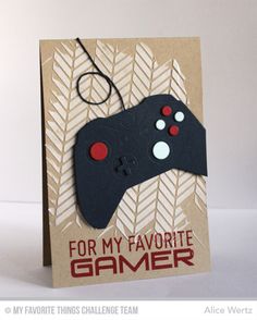 a handmade card with a video game controller attached to it's front side