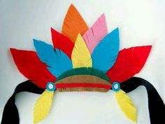 a colorful headdress made out of paper with feathers on it's side