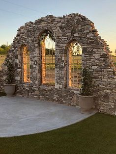 an old stone building with two arched windows