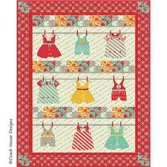 a quilted wall hanging with clothes on the clothesline and an image of children's dresses