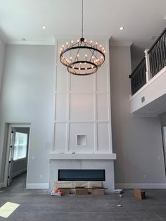 a chandelier hangs from the ceiling in an empty room with no one around it