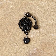 Black Gem Black Spiderweb Halloween Reversible Dangle Belly Ring If you're ready to get into the spirit of Halloween then you will love this 14 gauge navel jewelry with scary style! Made with a 3/8" black plated over 316L surgical grade stainless steel curved barbell, this reversible navel ring features a spiderweb dangle charm with a black gem spider as well as a black gem heart dangle charm that is perfect for trick or treating or a gothic ball.Specifications14 Gauge (1.6mm), 3/8" (10mm), Blac Black Piercings For Halloween Gift, Edgy Black Body Jewelry For Gift, Gothic Adjustable Body Jewelry For Halloween, Gothic Piercings For Halloween Gift, Spooky Black Jewelry For Halloween, Edgy Black Body Jewelry For Gifts, Adjustable Gothic Body Jewelry For Halloween, Emo Pierced Jewelry For Halloween, Black Gothic Body Jewelry Nickel Free