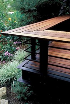 a wooden bench sitting in the middle of a garden