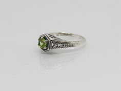 Vintage Sterling Silver Natural Peridot Filigree Ring ....Marked 925...Total of weights 2.9grams....Size 7....Measure of stone 5.1MM...It's in very good condition. Classic Silver Ring With Peridot, Classic Silver Peridot Rings, Classic Green Stackable Rings For Formal Occasions, Classic Green Oval Stackable Rings, Classic Green Stackable Rings, Classic Green Stackable Round Rings, Formal Sterling Silver Stackable Rings With Accent Stones, Classic Solitaire Peridot Ring, Heirloom Sterling Silver Green Ring