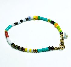 This playful, handcrafted bracelet boasts multicolored glass beads, a non-tarnishing stainless steel clasp, and a delicate, faceted glass charm.  The bracelet features a double string design on a black silk thread and is approximately 7.5 inches in length. The small glass beads measure roughly 3 to 4 mm in diameter. The bracelet will be delivered in a compact, cotton-filled Kraft box, ideal for storage or as a gift. Colors may vary slightly from your screen to real life. ⚠️This bracelet is not s Adjustable Czech Glass Bracelets With Tiny Beads, Czech Glass Bracelets With Tiny Beads As A Gift, Adjustable Czech Glass Beaded Bracelets With Faceted Beads, Adjustable Czech Glass Beaded Bracelet With Polished Beads, Czech Glass Beaded Bracelets With Tiny Round Beads, Adjustable Czech Glass Polished Beads Bracelet, Czech Glass Bracelets With Round Beads, Polished Czech Glass Beaded Bracelets, Faceted Heishi Beads Bracelets As Gift