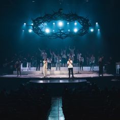 a group of people standing on top of a stage