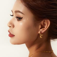 Embrace celestial elegance with Moon Drop Earrings, exquisitely crafted in 18k gold plating. These enchanting earrings feature a delicate moon design that gracefully dangles, adding a touch of mystical charm and elegance to any look. Elegant Gold Earrings With Moon Charm, Elegant Moon-shaped Earrings For Gift, Elegant Gold Half Moon Hoop Earrings, Elegant Half Moon Gold Hoop Earrings, Elegant Half Moon Earrings With Moon Charm, Elegant Moon Shaped Single Earring, Elegant Single Moon-shaped Earring, Elegant Crescent Moon Charm Earrings, Gold Crescent Earrings With Moon Phase Detail