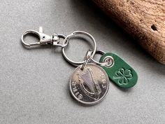 a keychain with a coin and shamrock on it