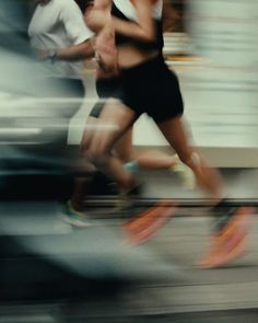 two people running in the street with blurry background