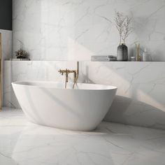 a white bath tub sitting in a bathroom next to a shelf with vases on it