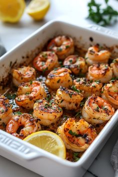 Shrimp scampi garnished with parsley and lemon in a white baking dish. Shrimp Thanksgiving Recipes, Cooking Shrimp On Stove, Easy Shrimp Meals, Pre Cooked Shrimp Recipes, Shrimp Dinner Recipes