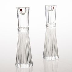 two clear glass vases sitting side by side