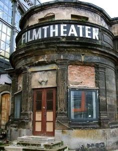 an old building with a sign that says hum theater