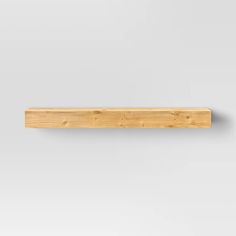 a piece of wood sitting on top of a white wall