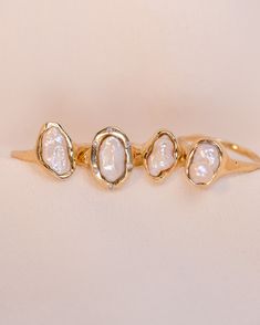 three gold rings with white stones on them