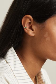 a close up of a person wearing a pair of ear piercings on their ears