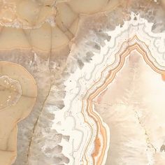 an aerial view of the desert with rocks and water on it's sides, including a bird flying in the distance