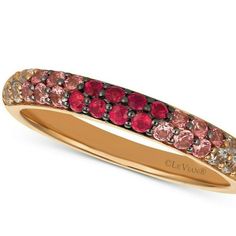 a gold ring with pink and red stones