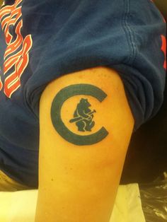 a man with a chicago cubs tattoo on his arm