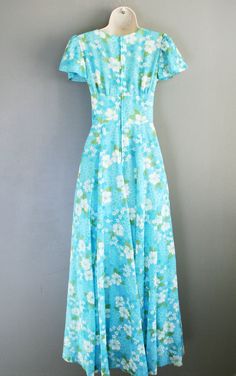 "This blue floral chiffon is truly lovely. It features a wide waistband and butterfly sleeves. Can be cut into a short dress or worn \"as is\". This dress shoes little to no sign of ever having been worn. It is in ready to wear condition. Estimated size S/XS 32\" bust 24\" waist full hip 40\" waist to hem Purveyor's Note: We have searched far and wide, wrestled bears, braved the cold, traversed mountain ranges, fought pirates, swam with sharks and eaten at many a questionable road side taco stan Vintage Fitted Chiffon Dresses, Fitted Vintage Chiffon Dresses, Vintage Floral Print Maxi Dress For Wedding, Blue Vintage Chiffon Dress, Vintage Blue Maxi Dress For Garden Party, Blue Vintage Maxi Dress For Garden Party, Fitted Vintage Chiffon Maxi Dress, Garden Party Wedding Guest, Boho Garden Party