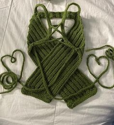 a crocheted green purse and matching handbag are laying on a white sheet