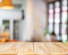 an empty wooden table with blurry background