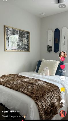 a bedroom with white walls and brown fur on the bedspread, two skateboards mounted to the wall