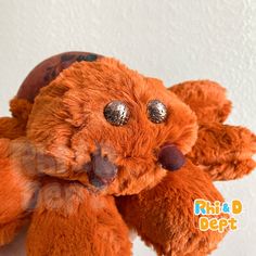 a close up of a stuffed animal on a white surface