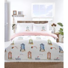 a bed with a white comforter and red striped bedspread on top of it