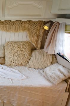 a bed with pillows and blankets on top of it