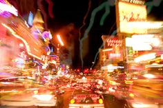 blurry photograph of busy city street at night