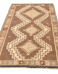 a brown and beige rug with diamonds on it