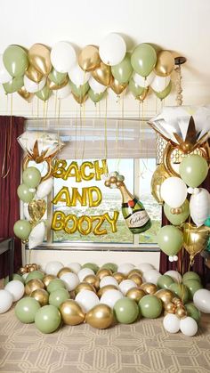 a room filled with balloons and streamers in the shape of champagne bottles on top of a table