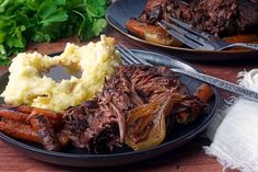 two plates with meat, mashed potatoes and carrots