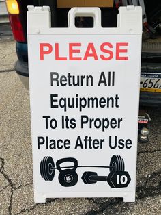 a sign on the back of a car stating to return all equipment to its proper place after use