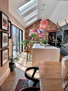 an open kitchen and dining room with skylights