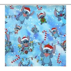 a blue christmas themed shower curtain with cartoon characters on it